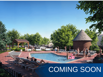 A pool area with people relaxing and a gazebo in the background.